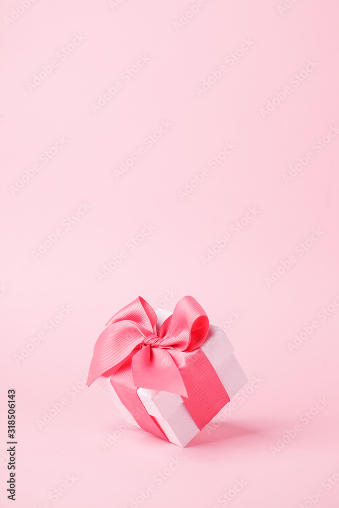 White gift box and on pink background with copy space for text. Luxury fashion, shopping sale concept. wedding, marriage or birthday composition. Coupon, flyer concept