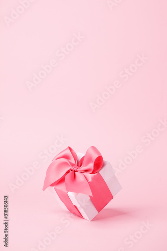 Obraz na płótnie White gift box and on pink background with copy space for text. Luxury fashion, shopping sale concept. wedding, marriage or birthday composition. Coupon, flyer concept w salonie