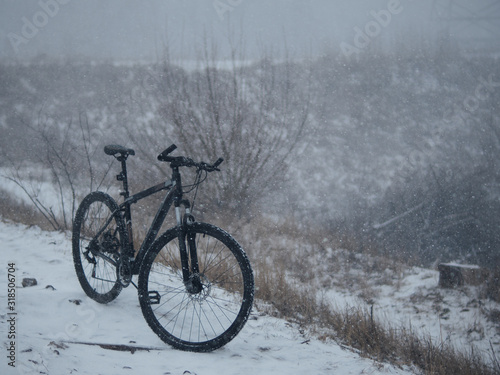 Bike in a heavy snowstorm © pavelkant