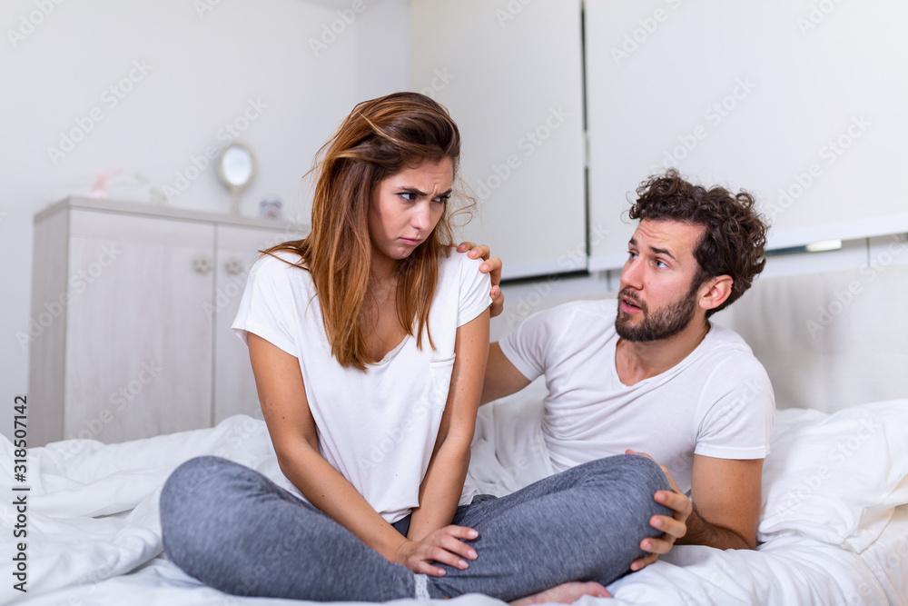 Couple With Problems Having Disagreement In Bed. Frustrated couple arguing and having marriage problems, Young couple into an argument on bed in bedroom Couple With Problems Having Disagreement In Bed. Frustrated couple arguing and having marriage problems, Young couple into an argument on bed in bedroom