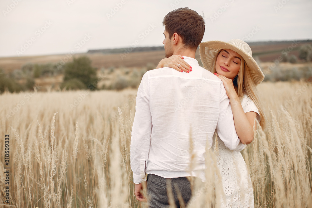 Cute couple in a field. Lady in a white dress. Guy in a white shirt Cute couple in a field. Lady in a white dress. Guy in a white shirt