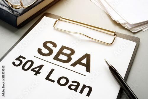SBA 504 loan agreement form and clipboard. photo