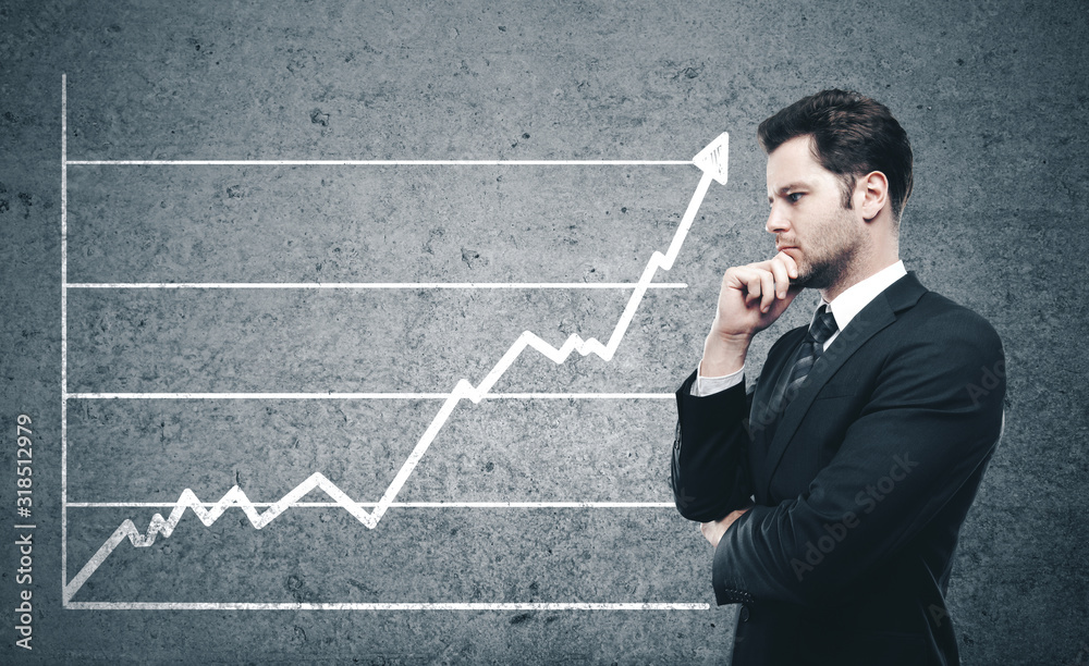 Businessman thinking and looking on business chart Businessman thinking and looking on business chart