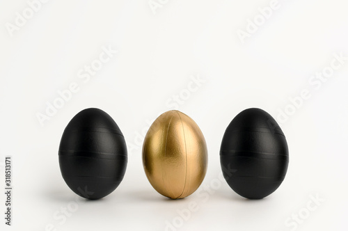 Three Easter golden and black decorated eggs isolated on white background. Line decorated. Minimal easter concept. Happy Easter card, copy space