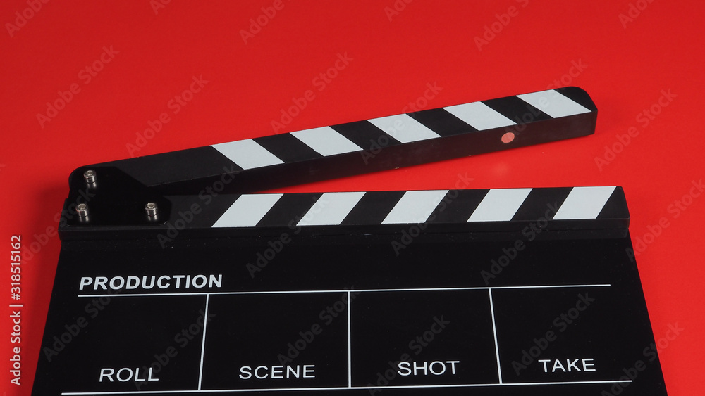 Clapperboard or clap board or movie slate .It is use in video production ,film, cinema industry on red background.