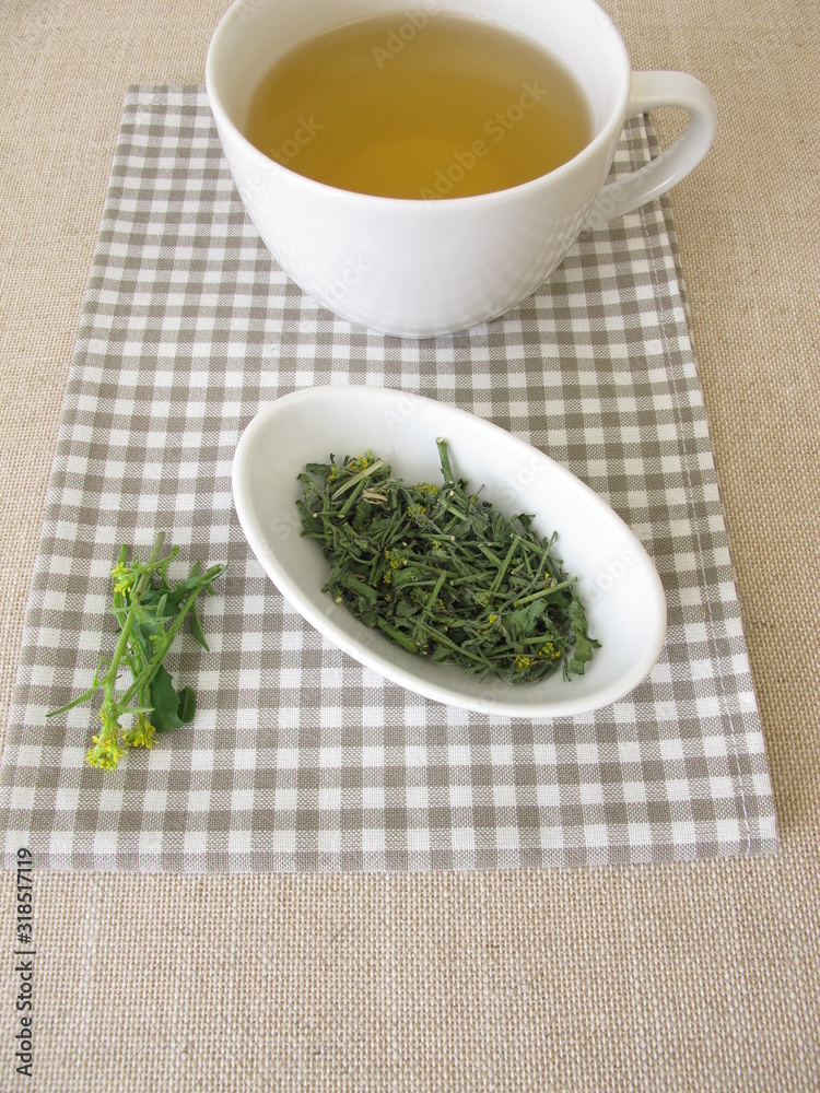 A cup of tea with dried hedge mustard A cup of tea with dried hedge mustard