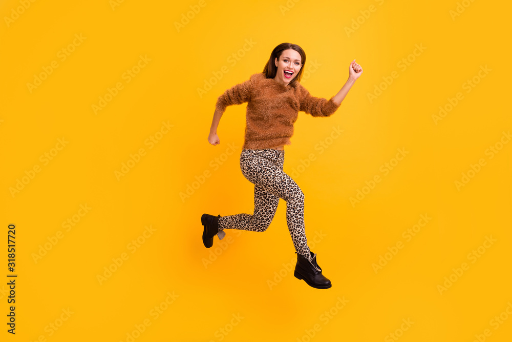 Full body profile photo of pretty traveler lady jump high fast rushing shopping low prices abroad sale wear fluffy pullover leopard pants footwear isolated yellow color background