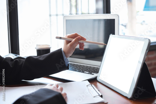 Business woman hand working with tablet in office.