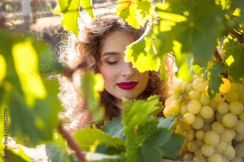 portrait of young pretty woman with beautiful make up posing outdoor on the green grape field