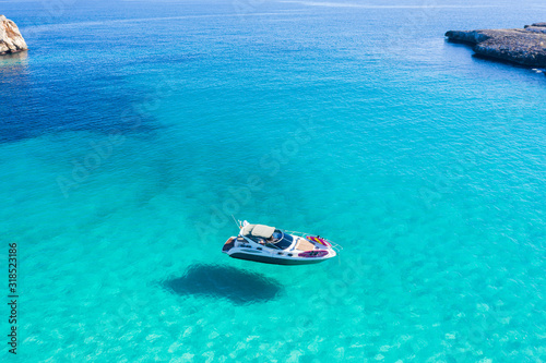 The boat in lagoon of Mallorca © castenoid