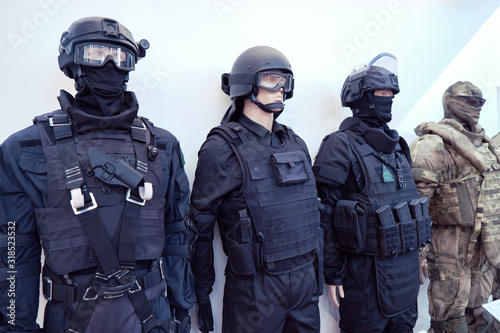 Mannequins in military and police camouflage with helmets, bulletproof vests and protective masks made of bulletproof glass photo