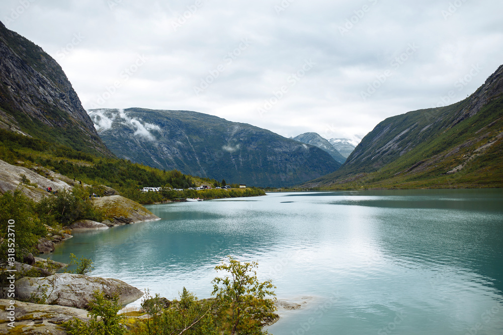 Picturesque landscape  mountains of Norway. Beautiful view of the lake. Rocky shore of mountain lake in the morning. Travelling, lifestyle,  wild nature concept.