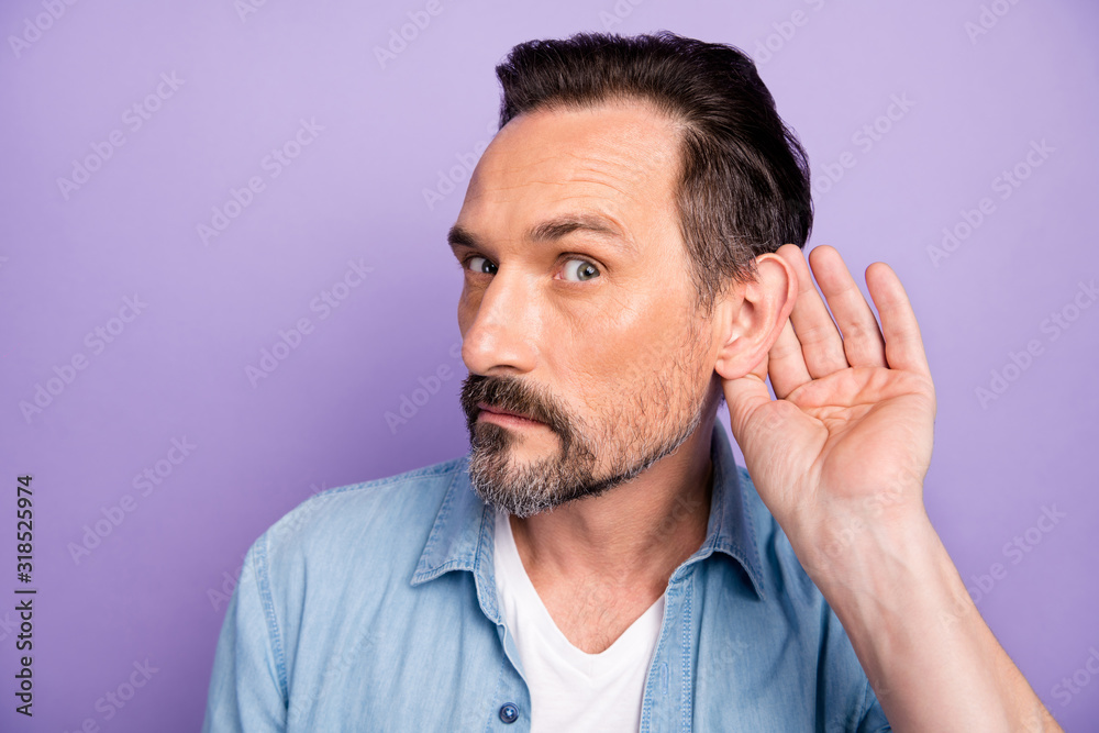 What did you say. Serious man hold hand near ears listen private communication want know interesting information wear good looking outfit isolated over violet color background What did you say. Serious man hold hand near ears listen private communication want know interesting information wear good looking outfit isolated over violet color background