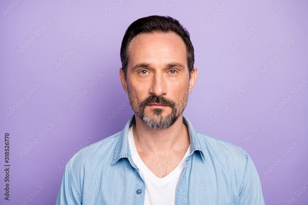 Portrait of serious masculine man freelancer good look wear stylish clothes isolated over violet color background Portrait of serious masculine man freelancer good look wear stylish clothes isolated over violet color background