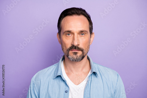 Portrait of serious masculine man freelancer good look wear stylish clothes isolated over violet color background