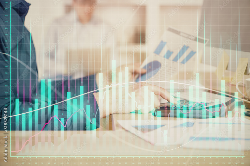 Double exposure of graph with man typing on computer in office on background. Concept of hard work. Closeup. Double exposure of graph with man typing on computer in office on background. Concept of hard work. Closeup.