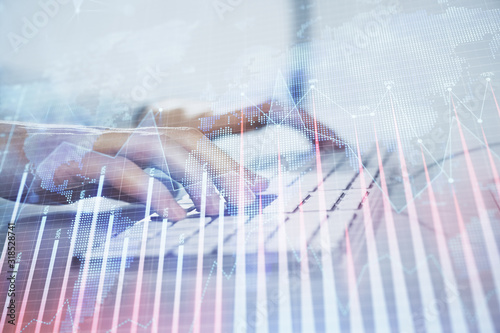 Forex graph with businessman working on computer in office on background. Concept of hardworking. Closeup. Multi exposure.