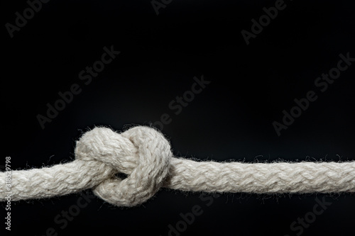 Sailor knot and rope isolated on a black background 