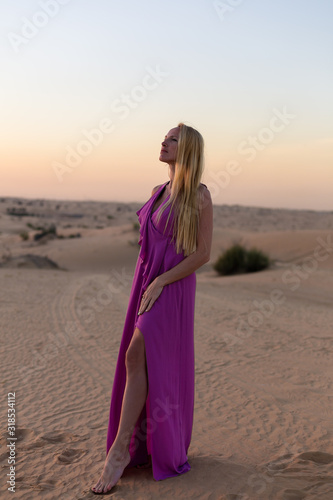 Blonde model in the desert in Emirates