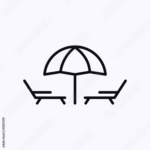 Two sun loungers under an umbrella