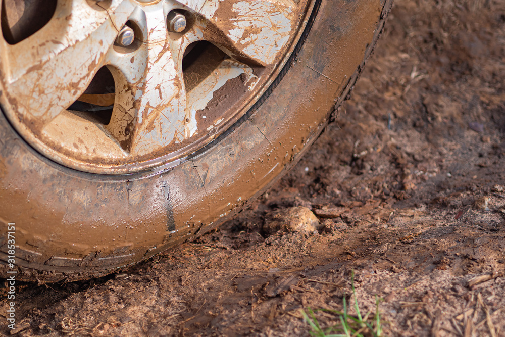 Close-up of muddy car wheels. Space for text