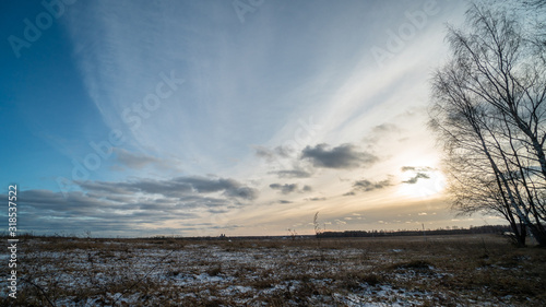 Beautiful setting sun over frozen field © Ni23