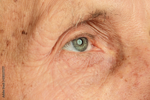 Close up, eyes. Caucasian senior man's portrait isolated on yellow studio background. Beautiful male emotional model. Concept of human emotions, facial expression, sales, wellbeing, ad. Copyspace.
