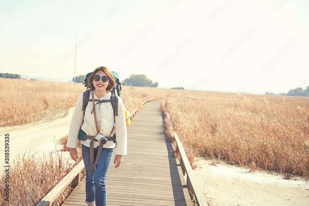 Korean woman is backpacking on an island in Korea.