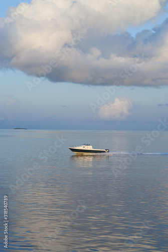 Motor boat on clear turquoise water... Maldives © osman