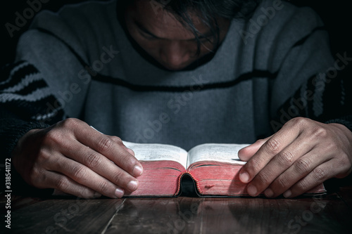 Christian praying with Bible, close up, Christian concept.