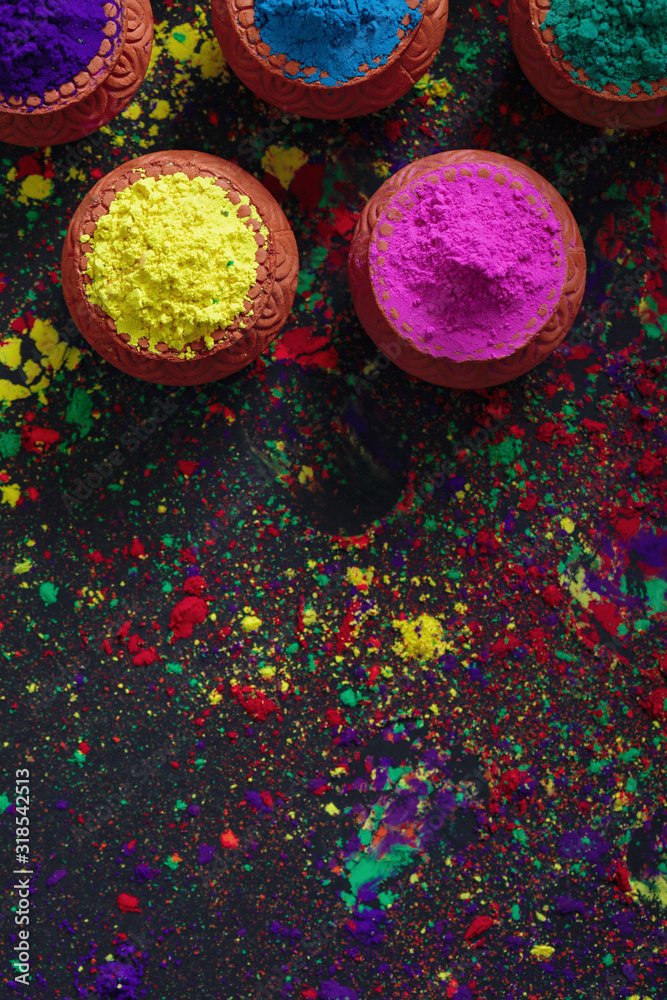 Fototapeta premium Indian Festival Holi, Colors in wooden bowl on dark background