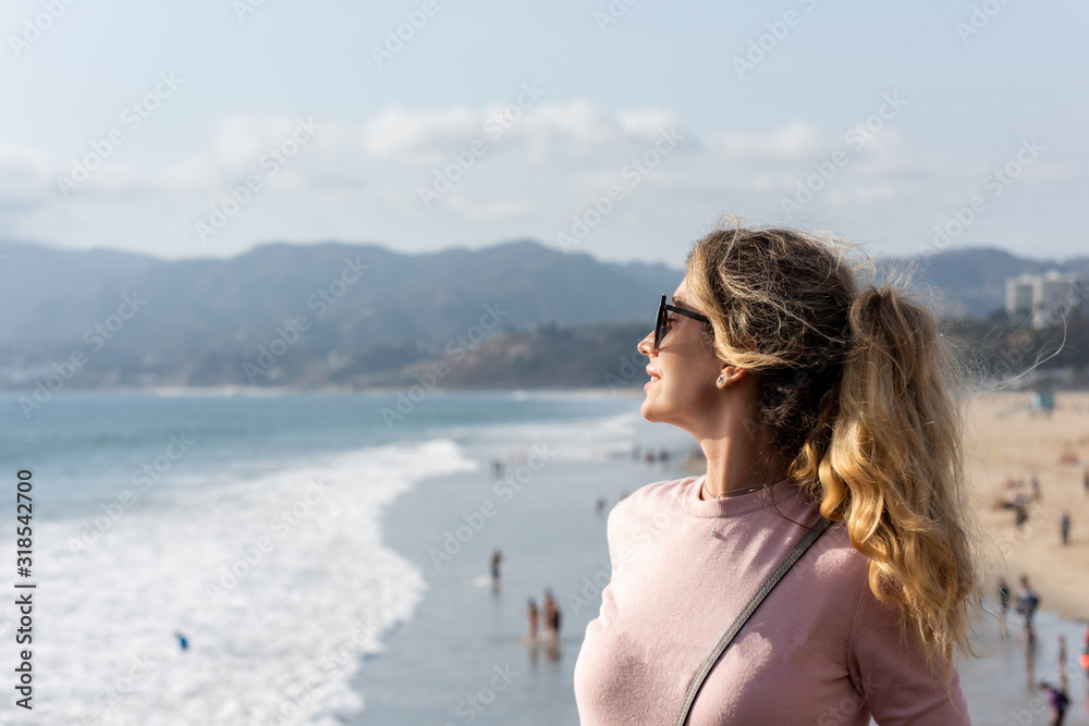 Happy blonde woman at the beach of Los Angeles