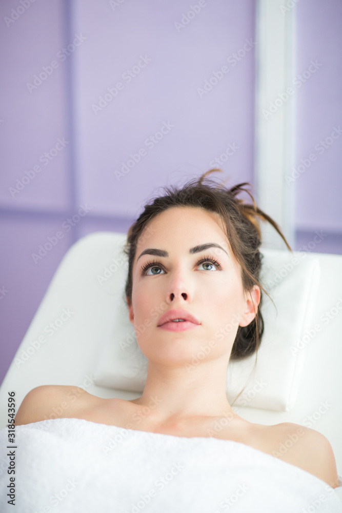 Relaxed woman is sitting in chair of beauty salon waiting for anti-aging treatments or an injection of hyaluronic acid Relaxed woman is sitting in chair of beauty salon waiting for anti-aging treatments or an injection of hyaluronic acid