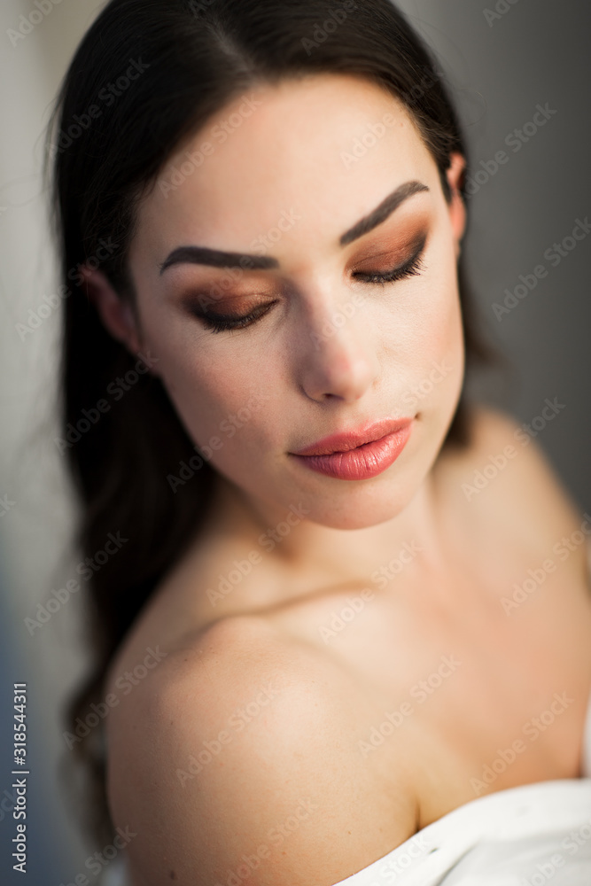 Makeup artist preparing beautiful female model for shooting Makeup artist preparing beautiful female model for shooting