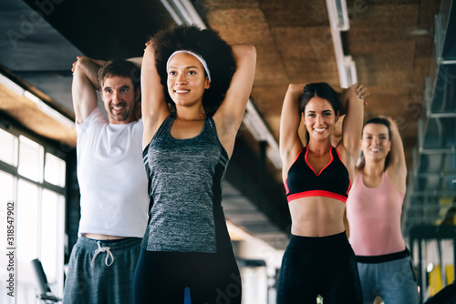 Group of fit people at the gym exercising