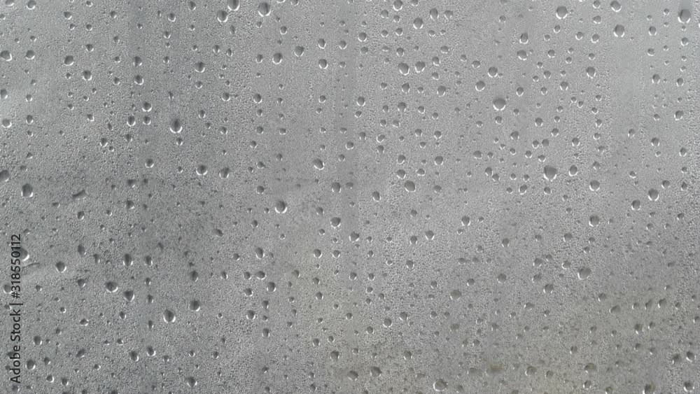 Many water drops on dark gray surface condensation. Abstract background texture. Many water drops on dark gray surface condensation. Abstract background texture.