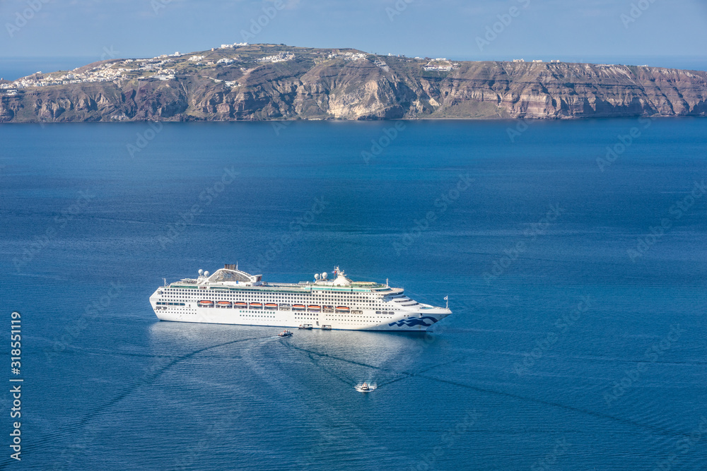 Cruise ship at the sea near the greek islands. Santorini island, Greece.