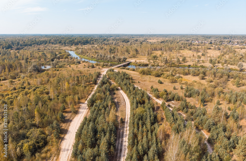 wooden bridge over a winding river, view from above