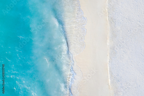 Fototapeta Naklejka Na Ścianę i Meble -  Summer seascape beautiful waves, blue sea water in sunny day. Top view from drone. Sea aerial view, amazing tropical nature background. Beautiful bright sea with waves splashing and beach sand concept