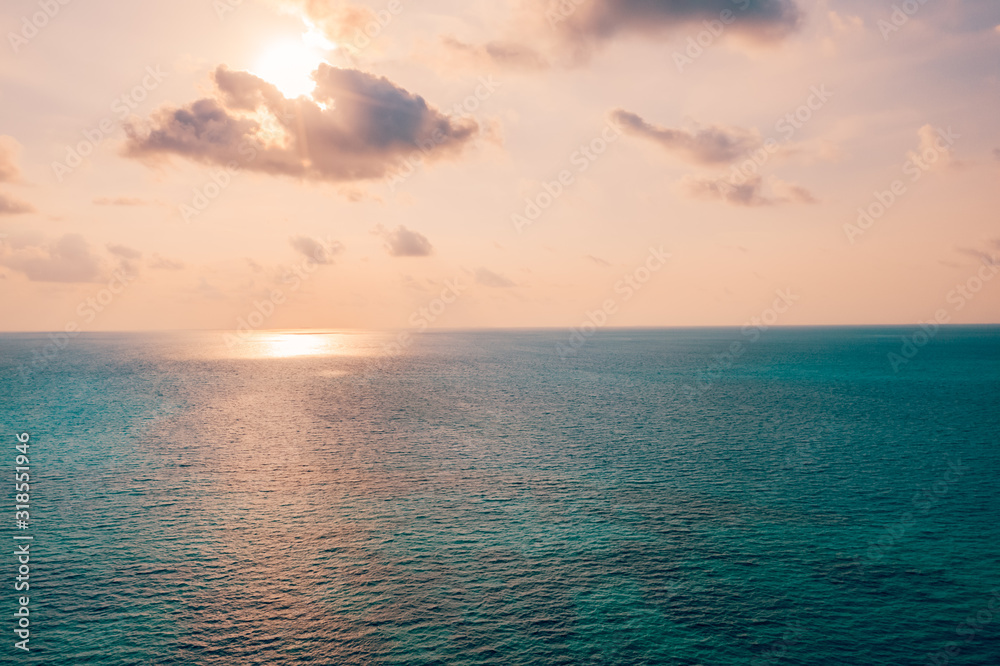 Obraz premium Inspirational calm sea with sunset sky. Meditation ocean and sky background. Colorful horizon over the water