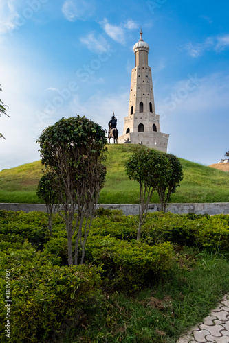 beautiful shot of fateh burj with warrior statue against sky in the background. outdoor and park concept.