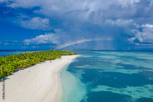 Aerial landscape, tropical island with stormy clouds and rainbow. Tranquil scenery, relaxing beach, tropical landscape design. Summer vacation travel holiday design
