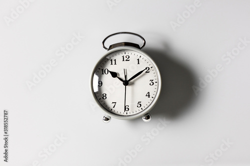 A white alarm clock on a white background