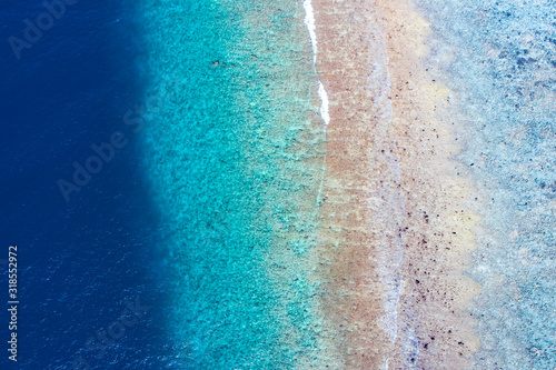 Sea ocean aerial view, top view, amazing marine nature background. Reef and coastal view, shades of blue