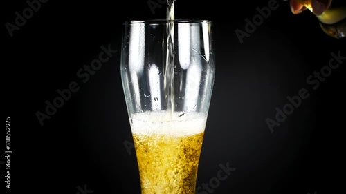 Beer ale. Freshly brewed beer is poured into a beer glass