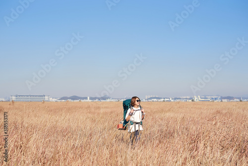 Korean woman is backpacking on an island in Korea.