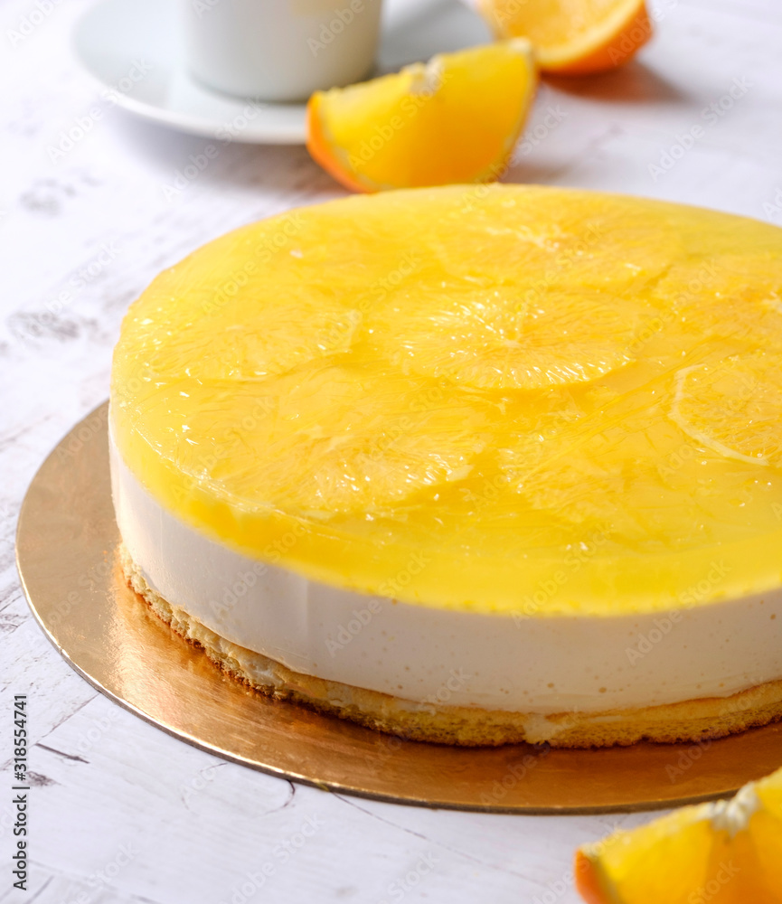 Homemade delicious sweet passion fruit orange cake, mousse dessert on cup of coffee americano, white background. Organic dessert sugarless. Healthy eating. Homemade delicious sweet passion fruit orange cake, mousse dessert on cup of coffee americano, white background. Organic dessert sugarless. Healthy eating.