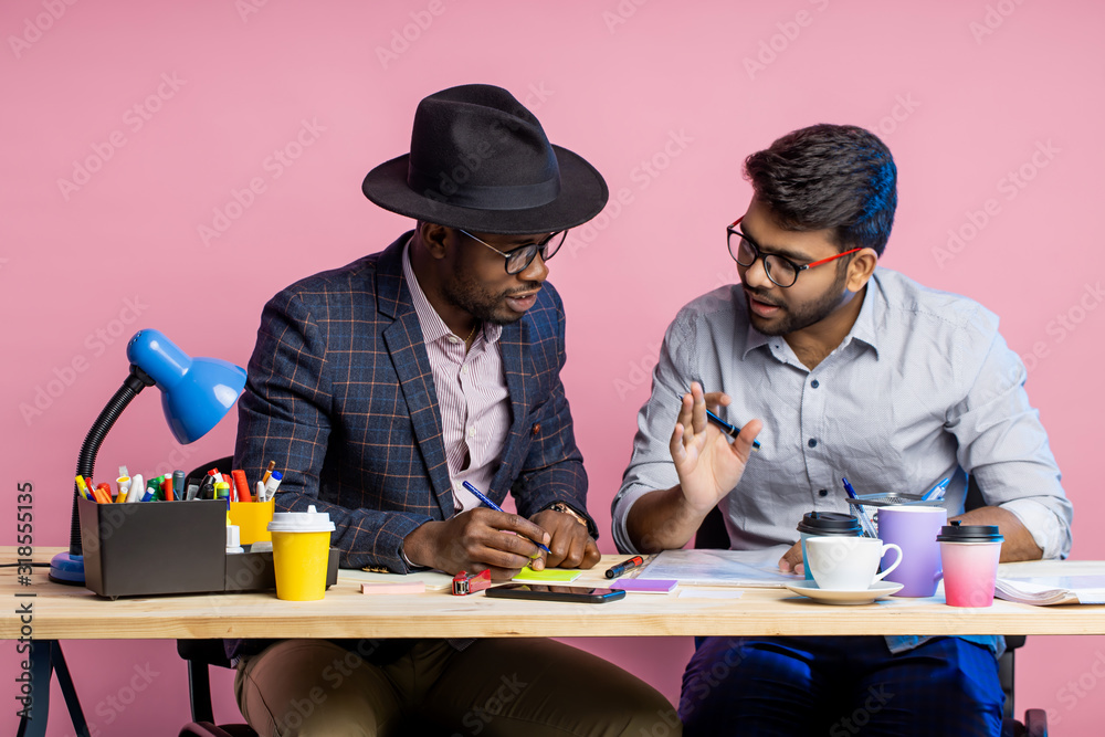 Two businessmen speaking and working at the office Two businessmen speaking and working at the office