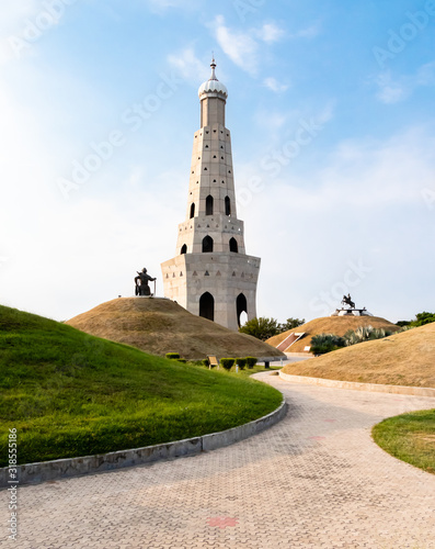potrait shot of fateh burj with baba banda singh bahadur against sky in the background. outdoor and park concept.