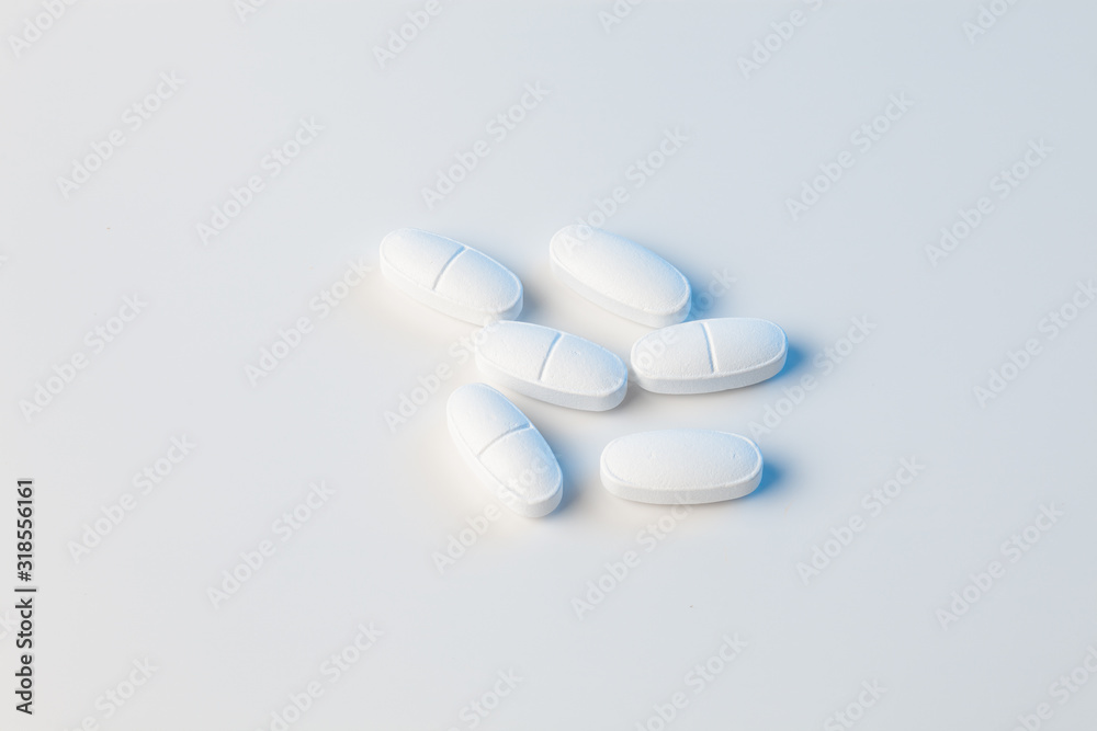 white pills on white background with blue lights white pills on white background with blue lights